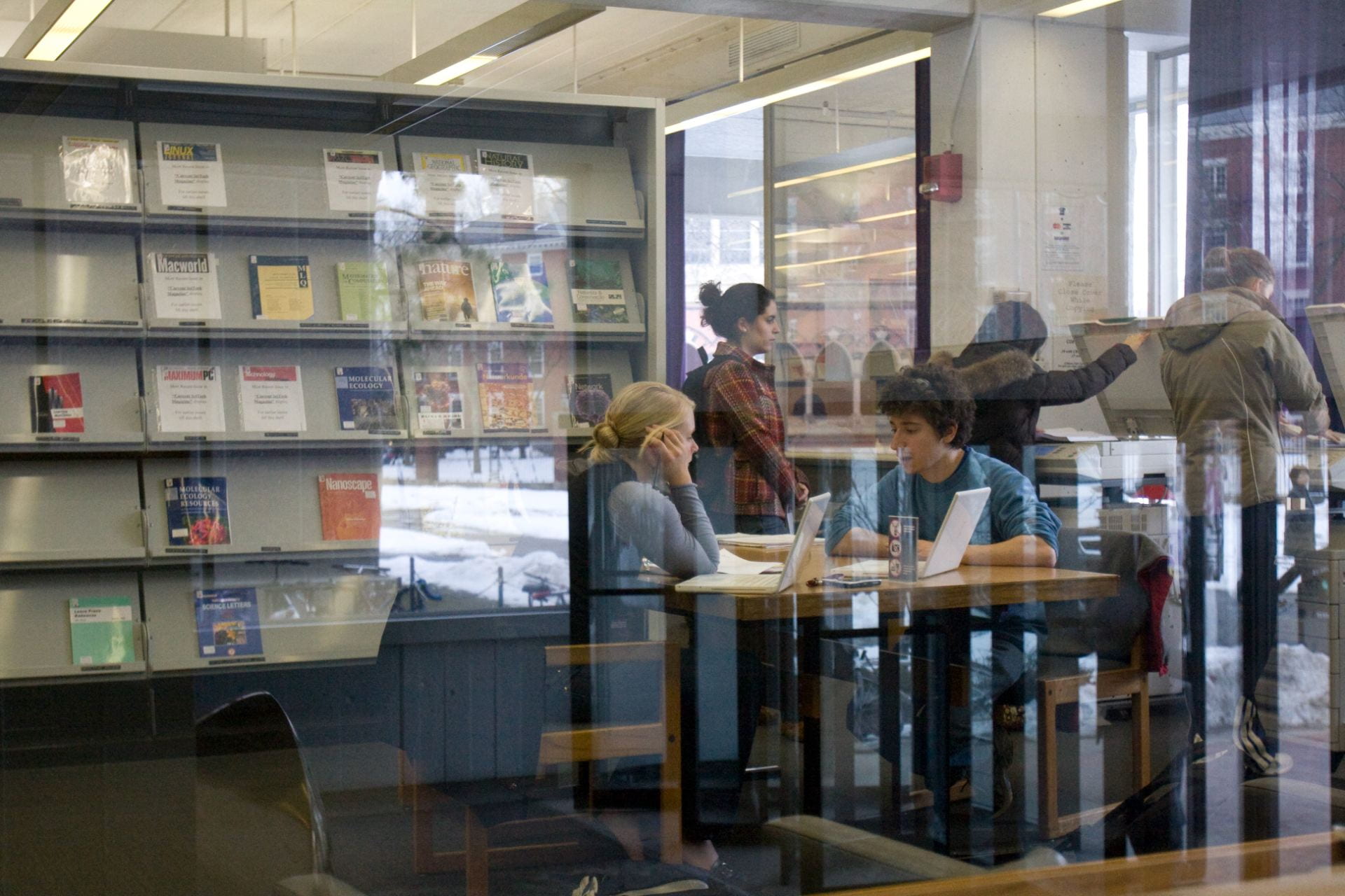 students talking at a table in cabot library